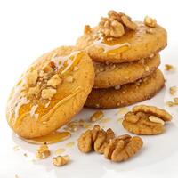 Stack of four honey cookies with walnuts on a white background photo