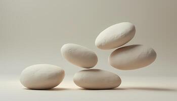 Five Smooth Stones Balancing and Floating on Beige Background photo