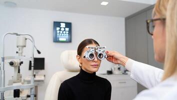 Optometrist conducting an eye examination with a patient in a modern clinic setting while using advanced testing equipment photo