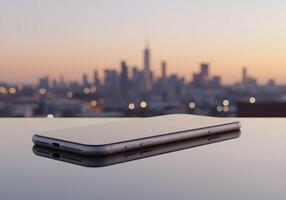 Smartphone on reflective surface with a blurred cityscape backdrop at dusk photo
