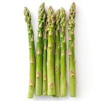 Green asparagus stalks with closed tips and white marks on top, arranged in a bundle. photo