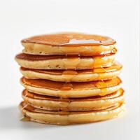 Fluffy stack of pancakes with syrup, presented on a white background. photo