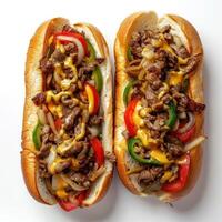Two hot dogs loaded with meat, cheese, and various vegetables. photo
