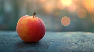 A peach on a table with bokeh photo