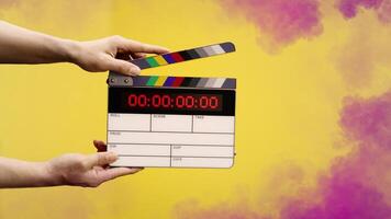 Digital film slate for filmmaker in set. Hand hitting timecode clapperboard or movie slate for Production. Digi number clapper board or film slates action on set. Tools in modern cinema industry photo