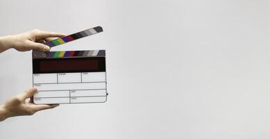 Digital film slate for filmmaker in set. Hand hitting timecode clapperboard or movie slate for Production. Digi number clapper board or film slates action on set. Tools in modern cine industry photo