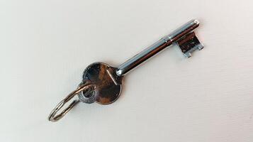 Antique house key isolated on background, key intact. photo