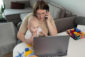 A busy parent struggles to balance work and caring for their baby while working from home photo