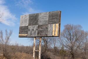 An empty billboard standing on the edge of the road photo