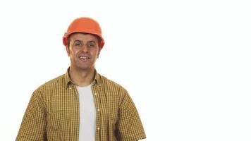 Cheerful mature builder in hardhat confidently posing with a drill machine video