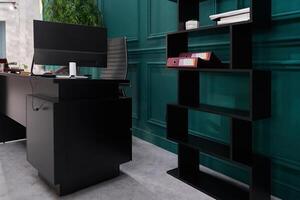 The luxurious office of the director of the company. It has a modern wooden table with a computer and an ergonomic armchair. Shelves for documents with space for copying photo