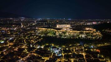 Aerial timelapse of Athens city skyline at night with the illuminated Acropolis, Parthenon, ancient ruins, and urban lights in Greece video
