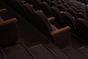 A hall with rows of empty chairs, an overhead view of the seating area. An empty event hall photo