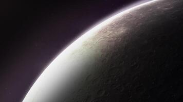 Surface of a planet with craters emerging from shadow in outer space video