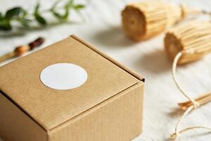 Minimalist product presentation with craft box, label and natural elements photo
