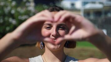 A woman making a heart with her hands video