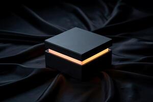 Minimalist box with illuminated glow, resting on luxurious dark silk fabric photo