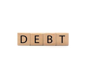 DEBT wooden text blocks isolated on white background. Copy space and clipping path. economic crisis risk and problem concept. Financial debt decrease, revenue management concept. Wooden Cubes. photo