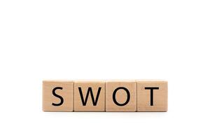Wooden blocks with SWOT text isolated on white background. wooden cubes SWOT with copy space and clipping path. SWOT analysis for Business concept. photo