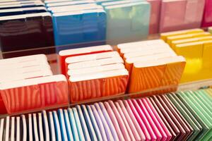 Colorful stationery display assorted notebooks. Colorful notebooks on store shelf. photo
