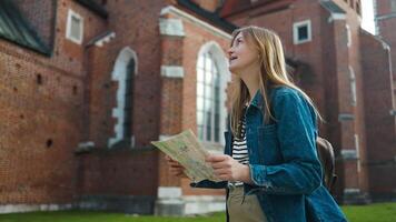Smiling tourist with map exploring Krakow city video