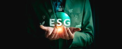 Business Professional Holding ESG Sustainability Concept with Digital Icons Representing Environmental, Social, and Governance Practices for Corporate Responsibility and Ethical Investment photo