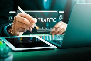 Business professional analyzing website traffic data using virtual interface with charts, graphs, and analytics tools on tablet and laptop for digital performance tracking and optimization. photo