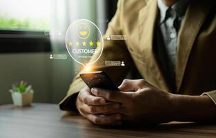 Businessman Using Smartphone to Review Customer Satisfaction Ratings with Digital Feedback Icons and Five-Star Review System for Online Service Quality and User Experience photo