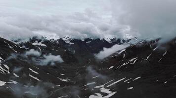 Snowy Mountain Peaks in Clouds Drone View video