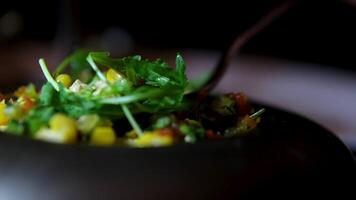 Frying an omelet with eggs, zucchini, and arugula in a pan in the kitchen. video