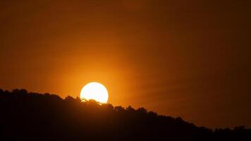 The sun rises over the mountains in a cloud da. video