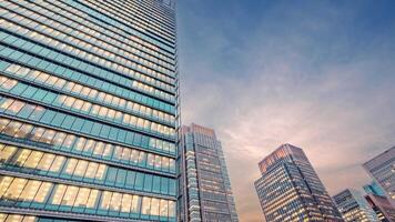 Twilight sky time lapse view looking up at modern office building. video