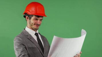Joyful architect proudly reviewing blueprints with a bright smile video