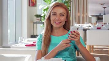 Joyful woman smiling brightly while using her smartphone at a chic restaurant video
