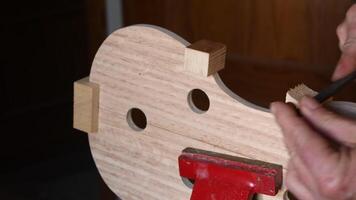 Luthier working in the structure of a violin video