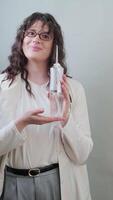 Orthodontist holds an irrigator and explains how it helps prevent cavities and gum inflammation. video