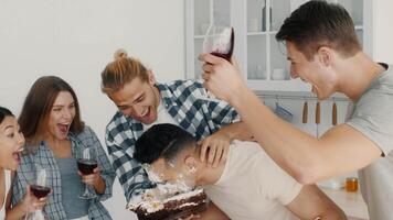 A lively gathering of diverse friends enjoying a fun celebration at home. They share laughs and drinks while engaging in playful activities, creating joyful memories together. video