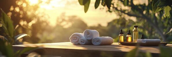 A wooden table with towels and oils on it photo