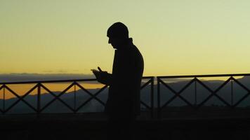 Silhouette of Nervous Angry Man Talking on the Phone at Sunset on a Balcony video