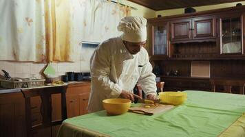 Home chef cuts Potatoes To Make Them Fried On The Table Of His Home Medium shot video