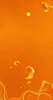 Orange liquid flowing over a surface with bubbles video