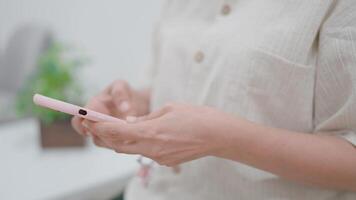 A person is using a mobile phone, with a focus on the hands and the device, showcasing interaction and technology in a modern setting. video