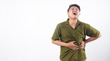 Man with pained expression clutching abdomen due to stomach issue isolated on white background photo