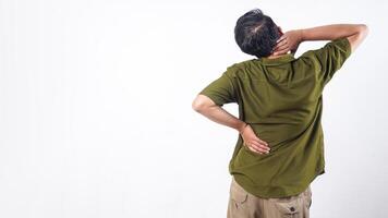 Rear view of man holding his lower back suffering from back pain isolated on white background photo