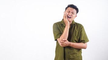 Unwell Asian man touch his jaw due to toothache isolated on white background photo