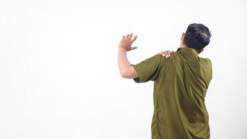 Rear view of man holding his shoulder suffering from shoulder pain isolated on white background photo
