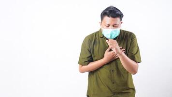Coughing man in face mask representing sickness isolated on white background photo