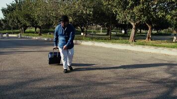 Traveler With A Suitcase Lost In A Park video
