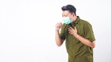 Man with protective face mask having persistent cough isolated on white background photo