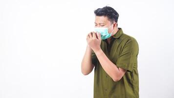 Man with mask suffering from bad cough isolated on white background photo